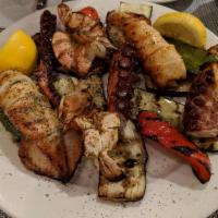 Broiled Seafood Combination · Octopus, shrimp and calamari over grilled vegetables.