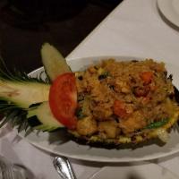 Pineapple Fried Rice · Chicken, prawns, eggs, carrots, peas, onions, scallions, tomatoes, raisins, cashew nuts and ...