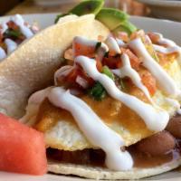 Huevos Rancheros · 2 eggs any style, bean, cheese, pico de gallo, avocado, sour cream, and house sauce, over co...