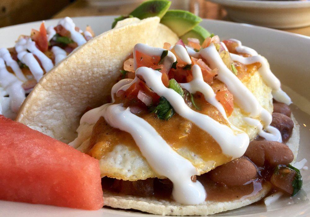 Huevos Rancheros · 2 eggs any style, bean, cheese, pico de gallo, avocado, sour cream, and house sauce, over corn tortillas.