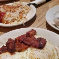Smokey Mountain Eggs · Biscuits with sausage gravy, 2 eggs any style and bacon on top.