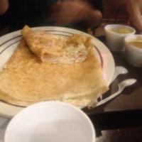 Rava Dosa · Crepe made from cream of wheat and rice flour stuffed with potatoes. Served with sambar and ...