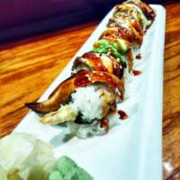 Dragon Roll · Shrimp tempura roll with cucumber, eel and avocado on top and topped with eel sauce.