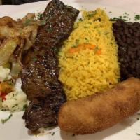 Grilled Skirt Steak · Fraldinha Grelhada. Served with rice, black beans, fried banana and onions.