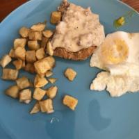 Country Fried Steak · Country fried steak, two eggs and a biscuit and gravy served with country taters.