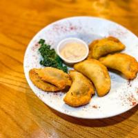 Bison Empanadas · Seasoned ground bison meat in a pastry shell fried golden and served with chipotle mayo.