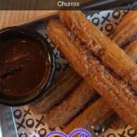 Churros · Sugar dusted and served with Mexican hot chocolate sauce.