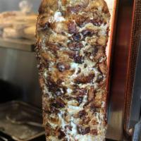 Chicken Shawarma Wrap · Served on lavash wrap - chicken Shawarma, spring mix, garlic sauce, pickles, & Mediterranean...