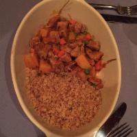 Lamb Tagine · A tender lamb cube stew with potatoes, peas, carrots, tomatoes, and Moroccan couscous.