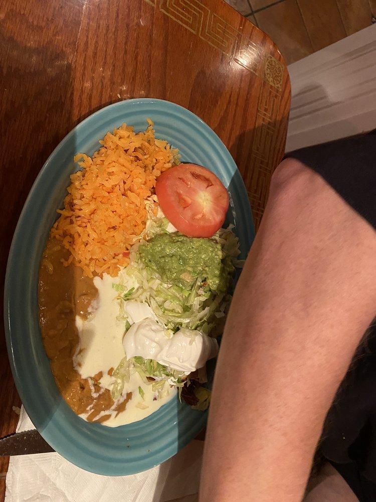 Chimichanga · 2 flour tortillas, soft or fried, filled with shredded beef and topped with cheese, lettuce, tomatoes, sour cream and guacamole. Served with Spanish rice and fried beans.