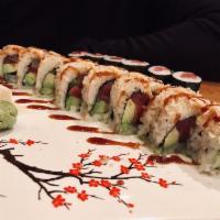 Snow Thrill Roll · Tuna, salmon, yellowtail and avocado inside, topped with crunchy flakes, served with spicy m...
