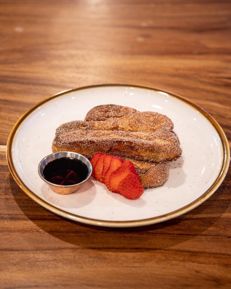 Java French Toast · slices of brioche dipped in orange scented batter, pan sautéed, dusted with cinnamon sugar, with pure Vermont maple syrup