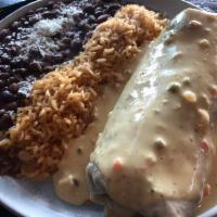 El Nebraska Burro · Flour tortilla stuffed with perfectly seasoned GROUND BEEF, cheese and red enchilada sauce t...