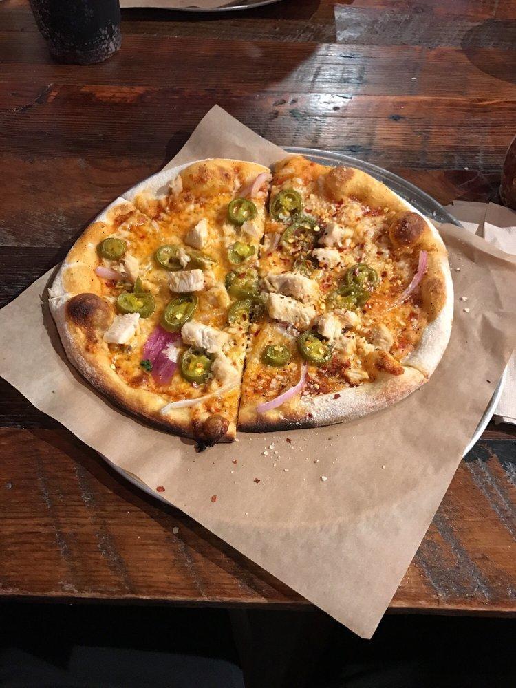 Southern Heat Pizza · House-made Buffalo sauce, melted mozzarella cheese, with red onions, fresh jalapenos, topped with grilled chicken. Includes your choice of ranch or bleu cheese on the side.