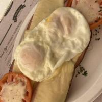 Croque Madame · Open French baguette with black forest ham, Swiss cheese baked under 2 fried eggs, with a to...