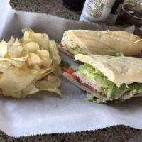 Tuna Sandwich · Chunky light tuna, mixed with mayonnaise, chopped red onions, celery, lettuce and tomato, to...