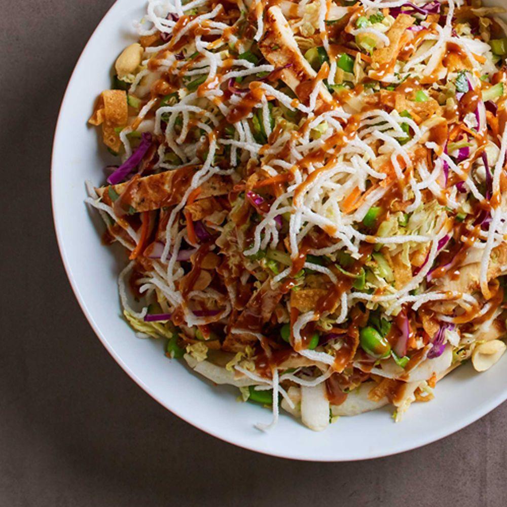 Thai Crunch Salad · Crisp veggies and fresh cilantro with chicken and the crunch of peanuts, wontons and rice sticks. Served with Thai peanut dressing.