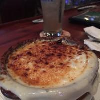French Onion Soup · Served in a crock and gratinee to perfection.