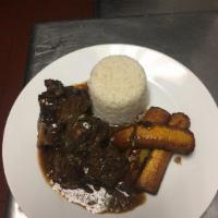 Braised Oxtail · Rice and Peas/Sweet Plantains or Steamed Cabbage