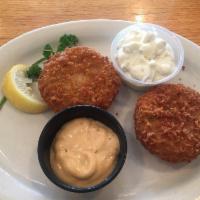 Crab Cakes · 3 crab cakes served over garden slaw and drizzled with a chipotle aioli.