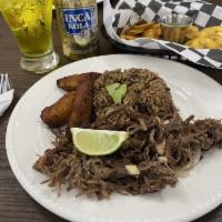 Vaca Frita · Pan-fried shredded skirt steak or chicken served with sauteed onions.