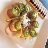 Butterfly Kisses Roll · Salmon wrapped crab mix, jalapeno, topped with lemon zest and ponzu. Marquee favorite.