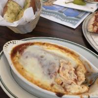 Manicotti · Homemade crepes stuffed with rich cheese, covered with zest tomato sauce and baked under moz...