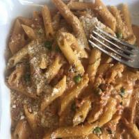 Penne Vodka · Pasta quills in a pink vodka sauce with fresh peas.