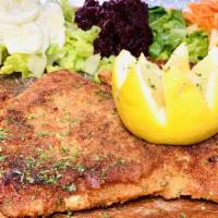 Chicken Schnitzel · Breaded chicken breast served with side of cabbage, cucumber and beet salad.