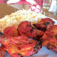Tandoori Chicken · 1/2 of spring chicken on the bone marinated in yogurt sauce with herbs and spices broiled on...