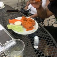 Hot Wings · Jumbo chicken wings, tossed with house buffalo sauce. Served with celery, carrots and your c...