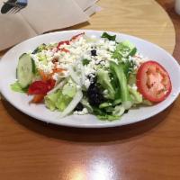 Greek Salad · Tomatoes, onions, cucumbers, green peppers, black olives and feta cheese.