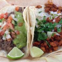 Al Pastor Taco · Served with onions, and cilantro 