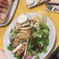 Greek Salad · Mixed greens tossed with Greek dressing, tomatoes, cucumbers, feta, Kalamata olives, onions,...