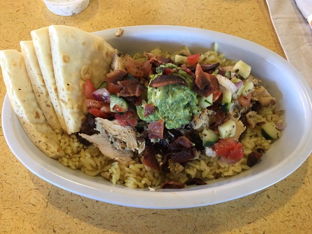 Greek Bowl · Seasoned basmati rice, roasted vegetables, and grilled chicken skewer or hand-carved gyro topped with fire feta sauce and warm pita.