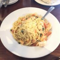 Shrimp Scampi · Sauteed in a white wine butter and garlic sauce served over spaghetti with tomato, basil and...