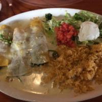 Spinach Enchiladas · 3 spinach and pico enchiladas covered with cheese sauce. Served with rice, lettuce, tomato, ...