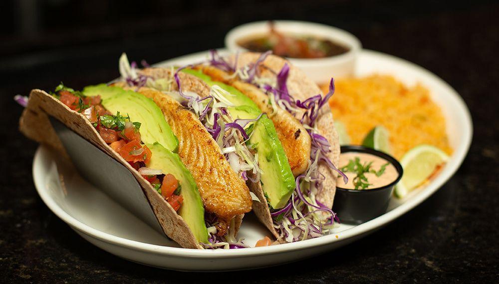 Grilled Fish Tacos · 2 grilled fish tacos on flour tortillas with shredded cabbage, sliced avocado and pico de gallo. Served with rice, black beans and homemade chipotle mayo.