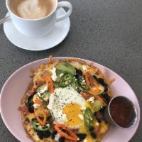 Huevos Rancheros · Black beans, crispy tostada topped with fried egg, avocado, fresh chilies, cherry tomatoes, ...
