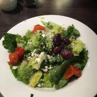 Greek Salad · Romaine, red cabbage, red leaf lettuce, feta, cucumber, roasted artichokes, oregano, green o...