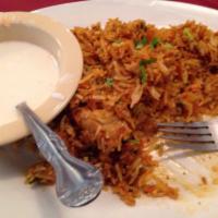 Chicken Biryani · Spiced basmati rice cooked with chicken and nuts.