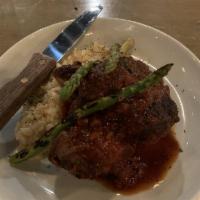 Hines Pork Osso Bucco · Braised pork shank with truffle risotto and grilled asparagus.