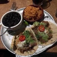 Carnitas · Michoacán braised pork, chicharónes, avocado tomatillo salsa, Cotija cheese.  Served as a si...