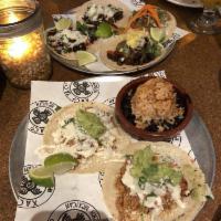 Chipotle Chicken Tinga · braised chicken thigh, queso Cotija, crema.  Served as a single taco OR 2 Tacos with Mexican...