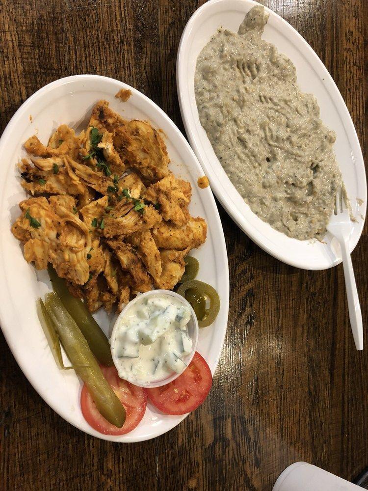 Chicken Shawarma · Boneless chicken marinated in lemon, yogurt, house spices and ground. Served with pickles and tomatoes.