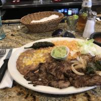 Carne Asada · A thin cut of authentically seasoned and grilled steak, guac on the side. Served with rice a...
