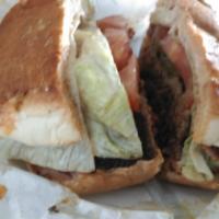 Colossal Burger · Pastrami, Thousand Island, tomato, pickle, onion.