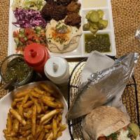Deluxe Sandwich · All 3 falafel flavors, hummus, Israeli salad, white and red cabbage, pickles, eggplant and t...