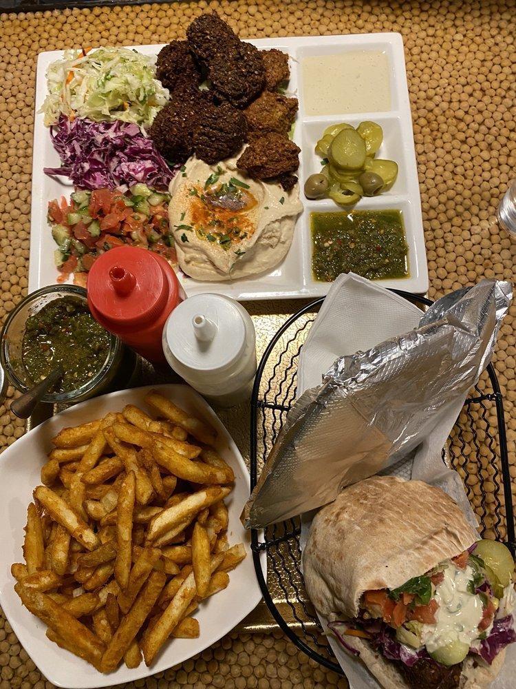Deluxe Sandwich · All 3 falafel flavors, hummus, Israeli salad, white and red cabbage, pickles, eggplant and tahini.