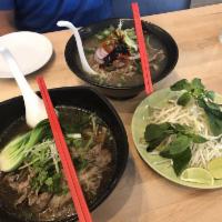Thai Boat Noodles · Slice beef, rice noodles, bean sprouts, green onion, bok choy and basil in slow cooked pork ...